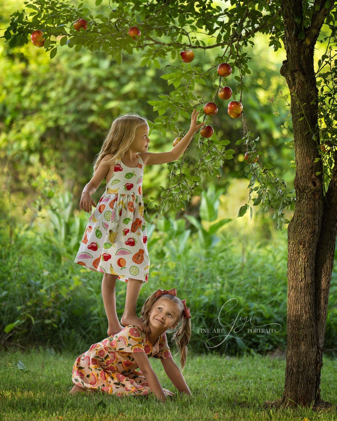 Another image of my darling nieces.  You can always count on your sister to help you out. And you can count on Gigi Fine Art Portraits to put apples on the tree when there aren't any yet! Feel free to share