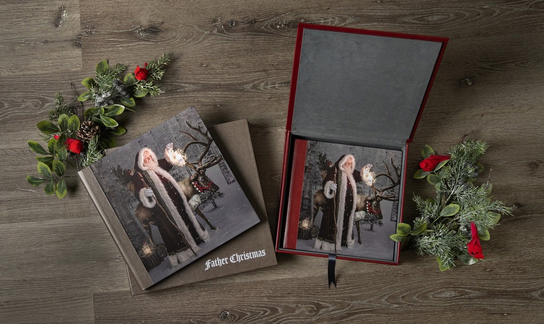 The Storybook Album is a client favorite and our most popular Fine Art Santa product. It is the best way to showcase all your Christmas images in one place; to share with friends and family and revisit each year to see how much the kids have grown. See the previous post for a video preview of our Father Christmas album!

Every album we create is custom designed for our clients, complete with your favorite image on the front cover.  Printed on heirloom quality fine art paper, our albums come with a choice of genuine leather, leatherette or linen cover material in a variety of color options. Order your album by itself or with a matching album box. Pictured here are our Father Christmas sample albums, in cedar brown and burgundy leatherette. Which color do you like better?